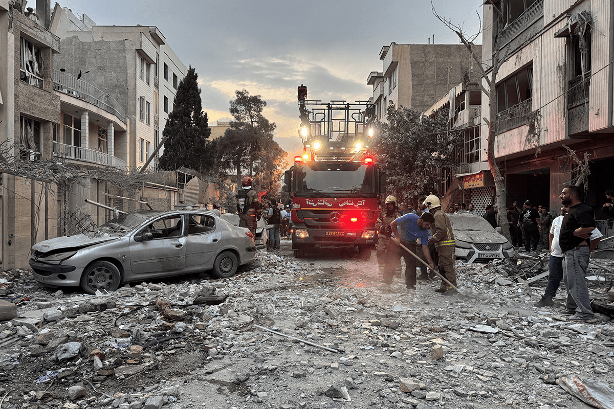 Emergency responders outside a building struck by an Israeli attack in Tehran on June 13. AFP